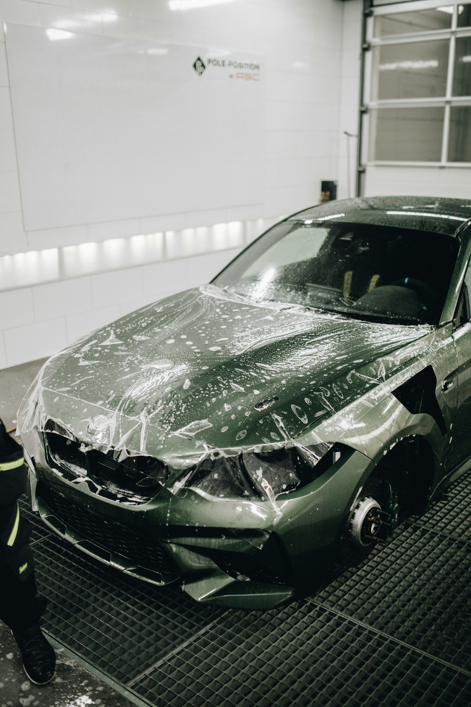 Paint protection film application in a detailing studio